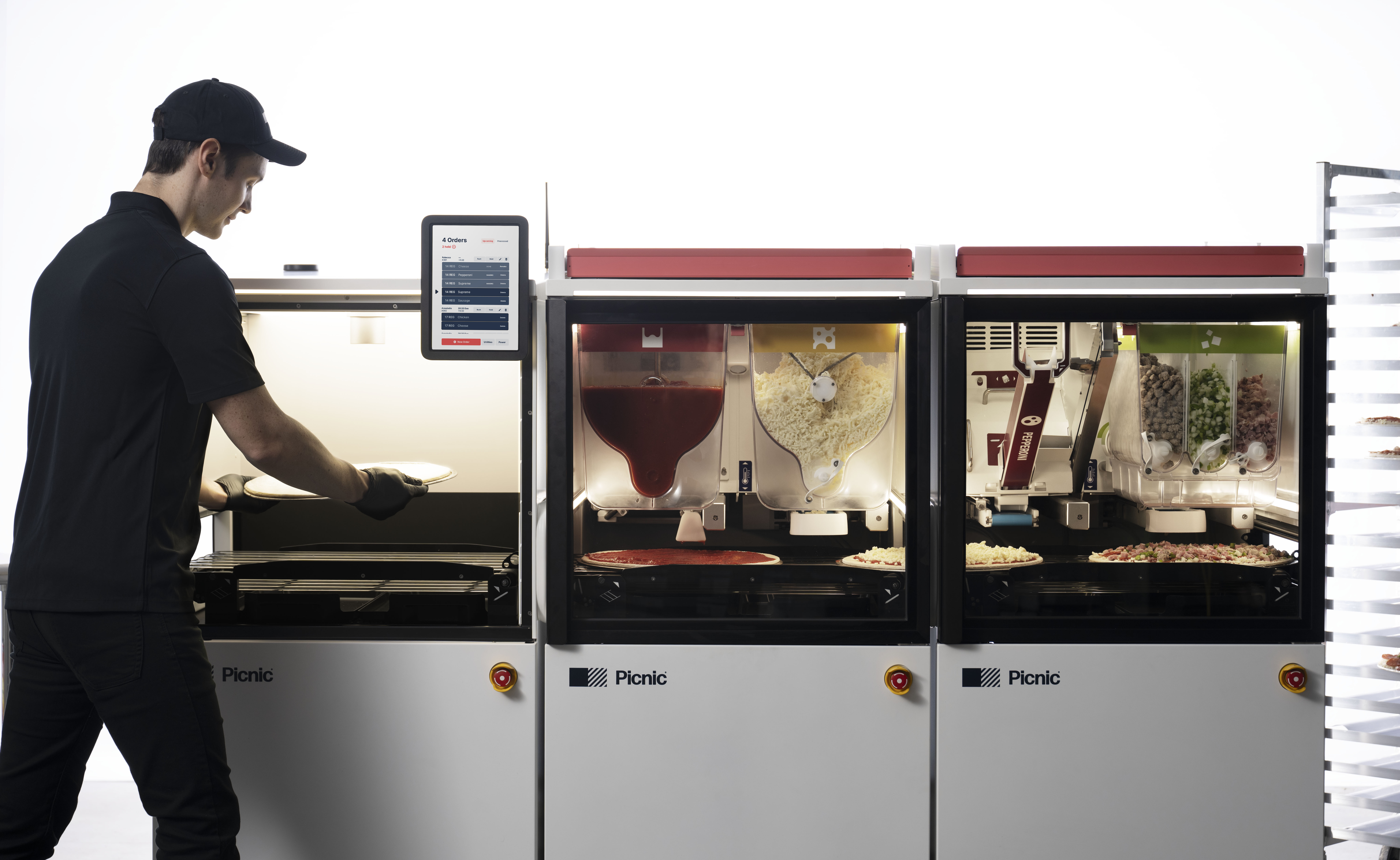 Place your crust on a screen in the dough feeder anywhere between the rails. The system uses a camera to determine the size, shape, and location of a dough so it knows exactly where to deposit ingredients.